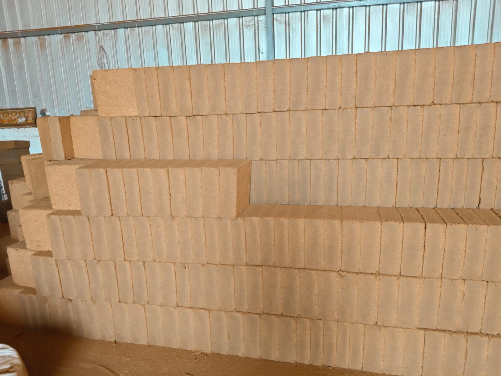 Rows of MiracleExim cocopeat compressed blocks stacked at the facility