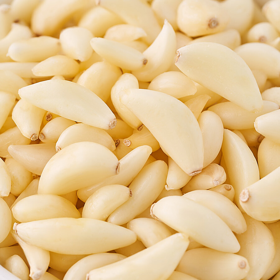 Individual peeled garlic cloves, separate from whole bulbs